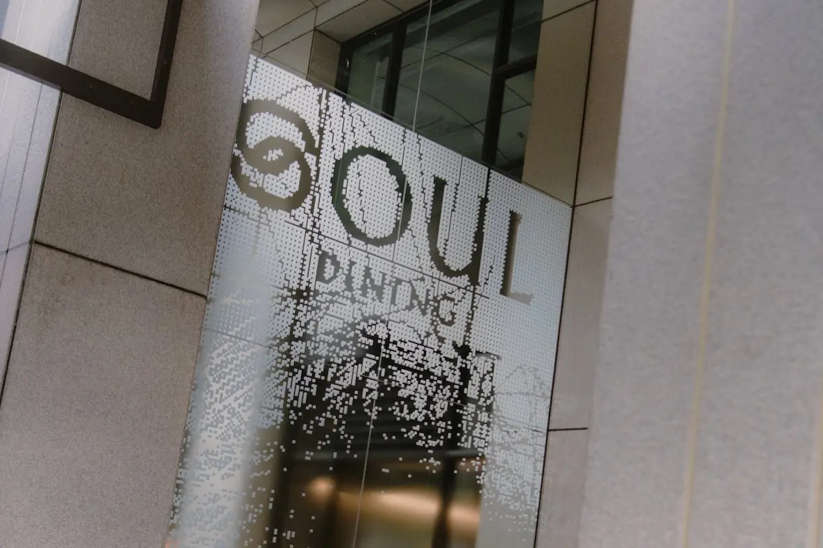 Close-up of a glass door with the text